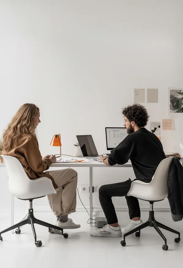Two people working together at a studio desk