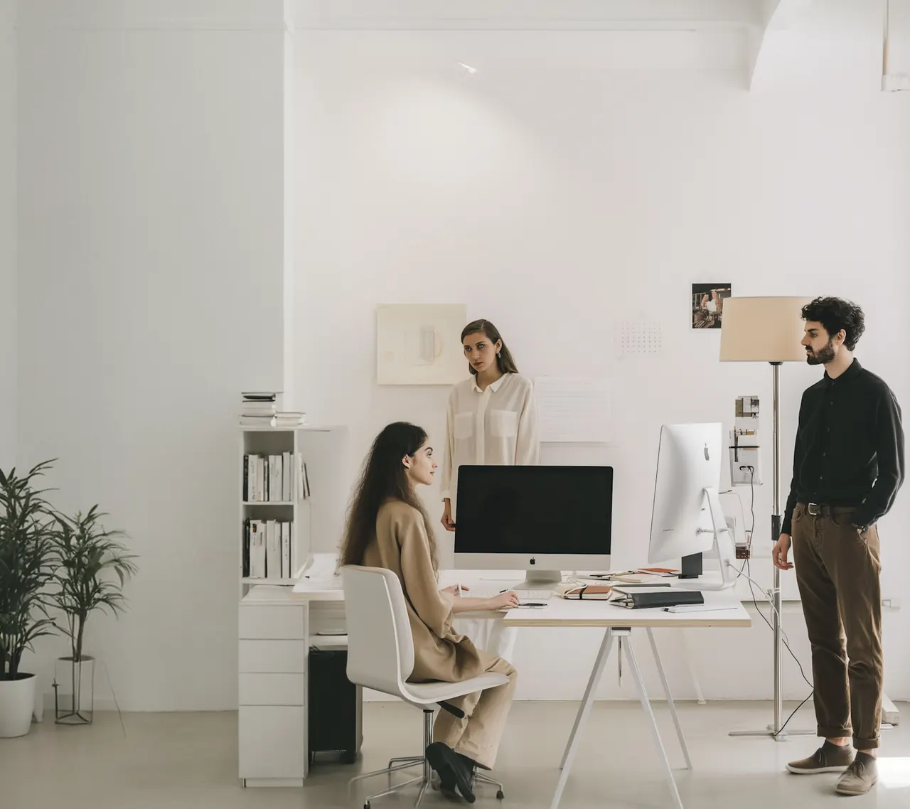 Norio studio — collaborators around a desk with screens