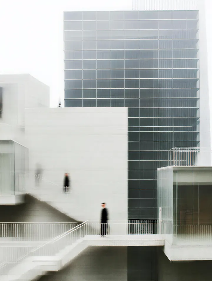 People walking on a white stair in a bright modern interior